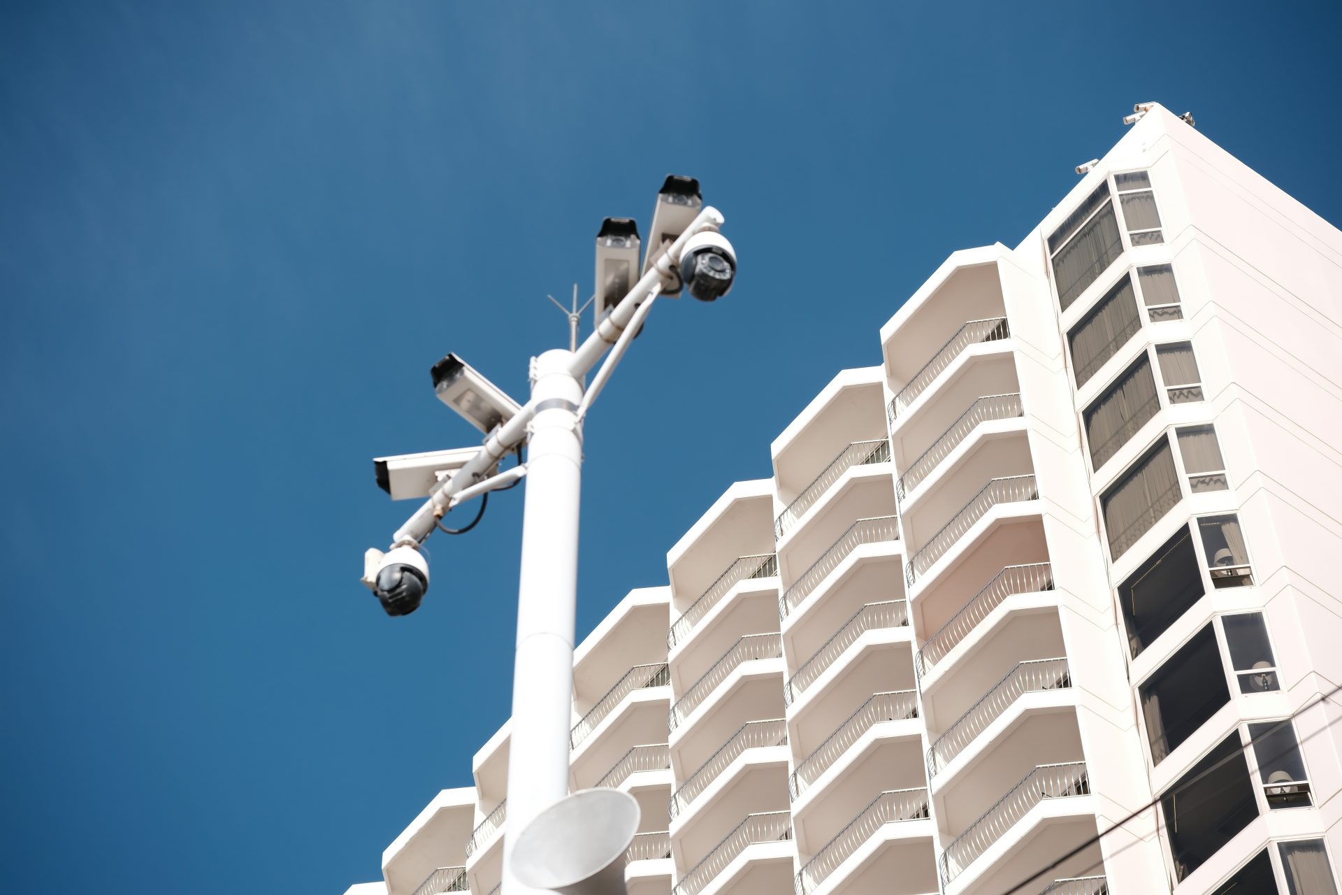 Security cameras mounted on a pole near a building.